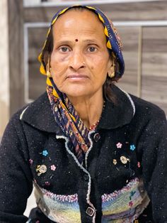 an old woman wearing a colorful head scarf