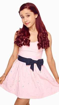 a girl in a pink dress with a blue bow on her head and red hair