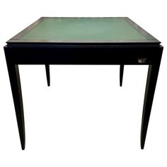 a small black table with green glass top