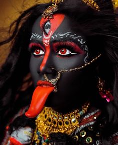 a close up of a woman with makeup on her face and tongue sticking out to the side