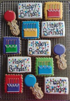 decorated birthday cookies on a cooling rack