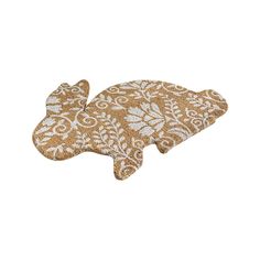 a brown and white fish shaped pillow on a white background with an intricate design in the middle