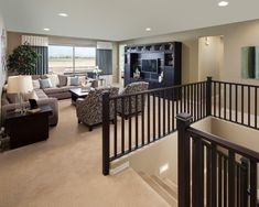 a living room filled with furniture and a flat screen tv