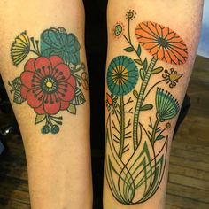 two tattoos with flowers on their legs