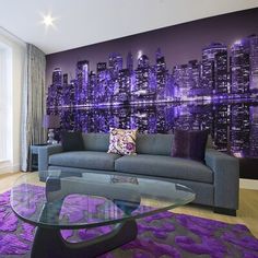 the living room is decorated with purple and black wallpaper, along with a glass coffee table