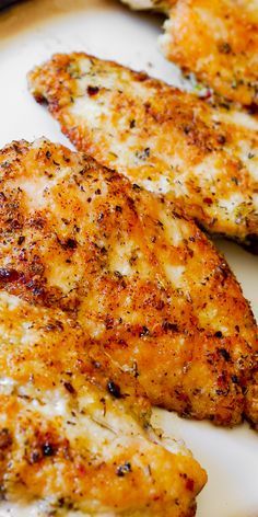 three pieces of chicken sitting on top of a white plate