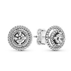 Let your ears do the talking with these Sparkling Double Halo Stud Earrings. Hand-finished in sterling silver, each stud features one big, raised central cubic zirconia surrounded by two halos decorated with more clear cubic zirconia. The outer halo sits slightly lower than the inner halo, with space in between them to add depth to the design. The outer halo is a detatchable earring jacket, so the earring can be styled with or without it. Style with a shimmering sterling silver bracelet for a so Pandora Earrings Studs, Pandora Earrings, Halo Stud Earrings, Halo Earrings Studs, Double Halo, Sterling Silver Studs, Pandora Jewelry, Sterling Silver Earrings Studs, 925 Sterling Silver Earrings