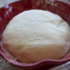 a loaf of bread in a red bowl