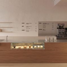 a bakery counter with pastries and coffee machines in the backgroung area