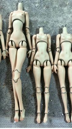 five mannequins are lined up on the floor in different positions and sizes