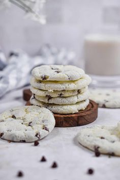 a stack of cookies sitting on top of a table next to a glass of milk