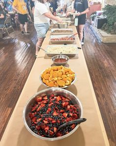 a long table filled with lots of different types of food on it's sides