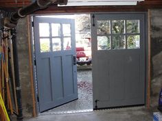 the inside of a garage with two doors open