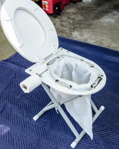 a white toilet sitting on top of a blue mat