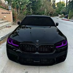 the front end of a black bmw car