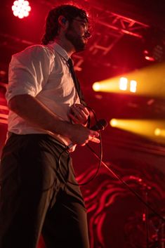 a man standing on stage with headphones in his ears