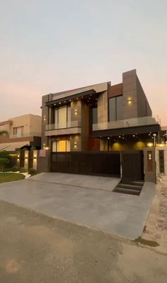 a modern house with an attached garage in the evening