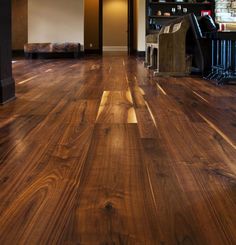 an empty room with wooden floors and furniture