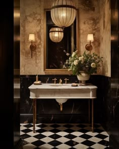 a bathroom with a checkered floor and black and white tile on the floor, two sinks in front of a large mirror