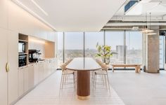 an open kitchen and dining area with large windows looking out onto the cityscape