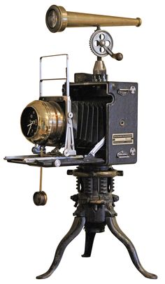 an old fashioned camera sitting on top of a tripod with a telescope attached to it