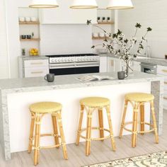 three stools are in front of the kitchen island with marble counter tops and gold barstools