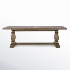 an old wooden table with two legs and a long slab on one end, against a white background