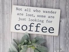 a sign that says not all who wander are lost, some are just looking for coffee