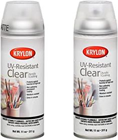 two cans of krylon u - resistant clear acrylic paint on a white background