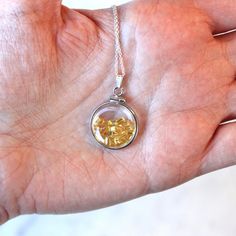 "Vibrant handcrafted brand new sterling silver genuine yellow sapphire shaker locket! This radiant pendant is dime sized with coin style bezels, and clear lucite covers. The round charm showcases genuine fancy sapphires in bright yellow hues. There is an estimated 2.5 CTW of faceted baguette cut sapphires sparkling within the double sided locket's clear lucite covers. A gorgeous piece of brand new gemstone jewelry, featuring beautiful genuine gems! ERA - New METAL / MATERIAL - Sterling silver lo Gemstones Pendant, Fancy Sapphire, Yellow Hues, Sterling Silver Locket, Logo Gifts, Lancaster Pa, Silver Lockets, New Metal, Baguette Cut