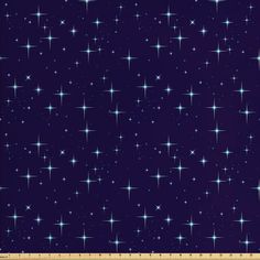 a ruler is next to a blue background with white stars on the dark purple ground