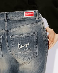 These cropped Japanese denim jeans are made with a seasonal medium blue stone wash inspired by the vintage 'KENZO Jeans' designs of the 80s. The back pocket features the brand signature along with a poetic message 'Création pour un monde plus beau' (Creation for a more beautiful world). The straight cropped cut lends it a straight-leg shape with a regular waist.'BARA' cropped Kaihara Japanese denim jeans.'KENZO Archive' embroidery on the back.'KENZO Paris' signature and 'Création pour un monde p Denim Pocket Embroidery, Denim Embroidery Jeans, Hand Embroidery Jeans, Japanese Jeans, Stone Wash Jeans, Jeans Ideas, Denim Label, Denim Embroidery, Kenzo Paris