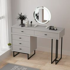 a dressing table with a mirror, vase and plant on it next to a window