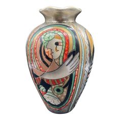 a vase with an artistic painting on it