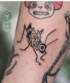 a close up of a person's arm with a tattoo on it and an image of a bug