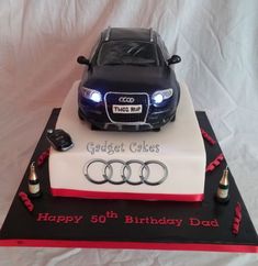 a birthday cake with an audi car on top