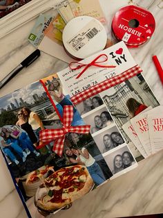 a table topped with pictures and other items on top of a white marble countertop