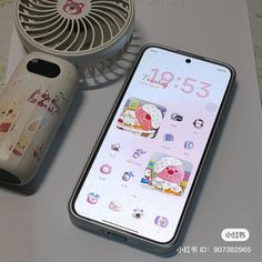 the phone is next to an air conditioner and some other items on a table