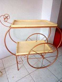 two wooden trays sitting on top of a metal cart