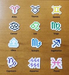 an image of some pixelated stickers on a wooden surface with the words zodiacs