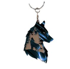 a blue and white dog with trees on it's head is hanging from a silver chain