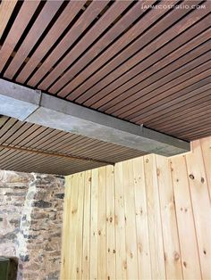 a wooden ceiling with metal beams attached to it