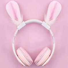 pink headphones with bunny ears are on top of a pink background and there is no image here to provide a caption for