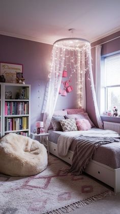 a bedroom decorated in pink and white with lights strung from the ceiling