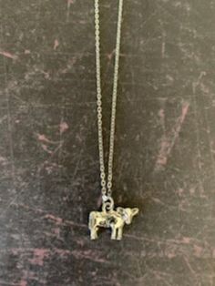 Cute and nicely detailed double sided silver tone holstein cow necklace.  Pendant measures 1/2" L X 3/4" W and is an 18" chain. ★ Want to see more?  Please visit my shop at: https://www.etsy.com/shop/DesignsByPeg Cow Jewelry, Cow Necklace, Small Cow, Holstein Cow, Western Necklace, Holstein Cows, Western Necklaces, Saint Marys, Necklace Dainty