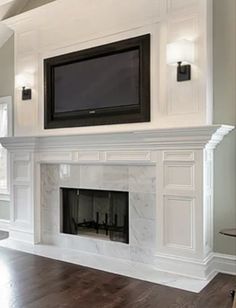 a living room with a fireplace and tv mounted on it's wall above the fire place