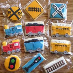 decorated cookies in the shape of trains and traffic signs