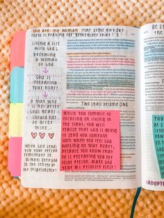 an open bible with colorful paper on it