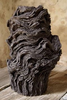 a close up of a sculpture on a wooden table