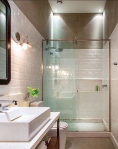 a bathroom with a glass shower door and white sink counter top next to a walk in shower